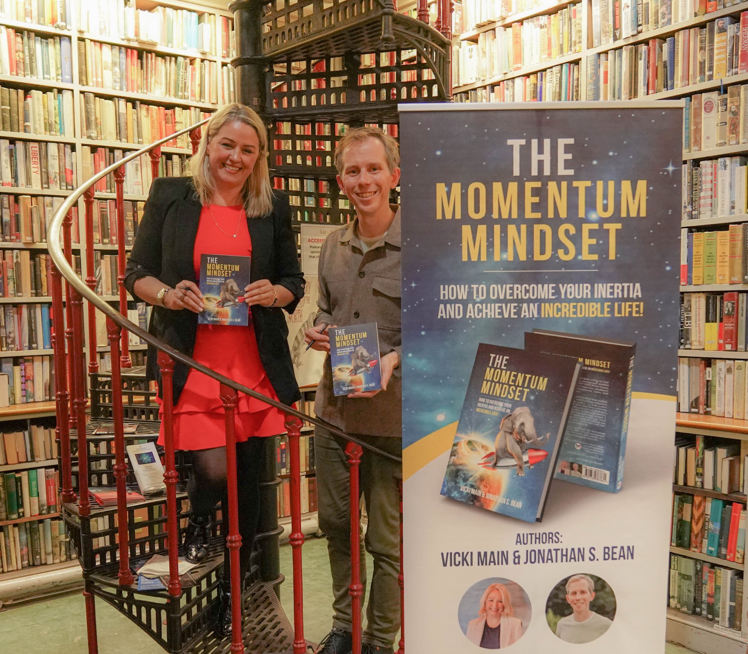 Vicki Main & Jonathan Bean holding The Momentum Mindset book